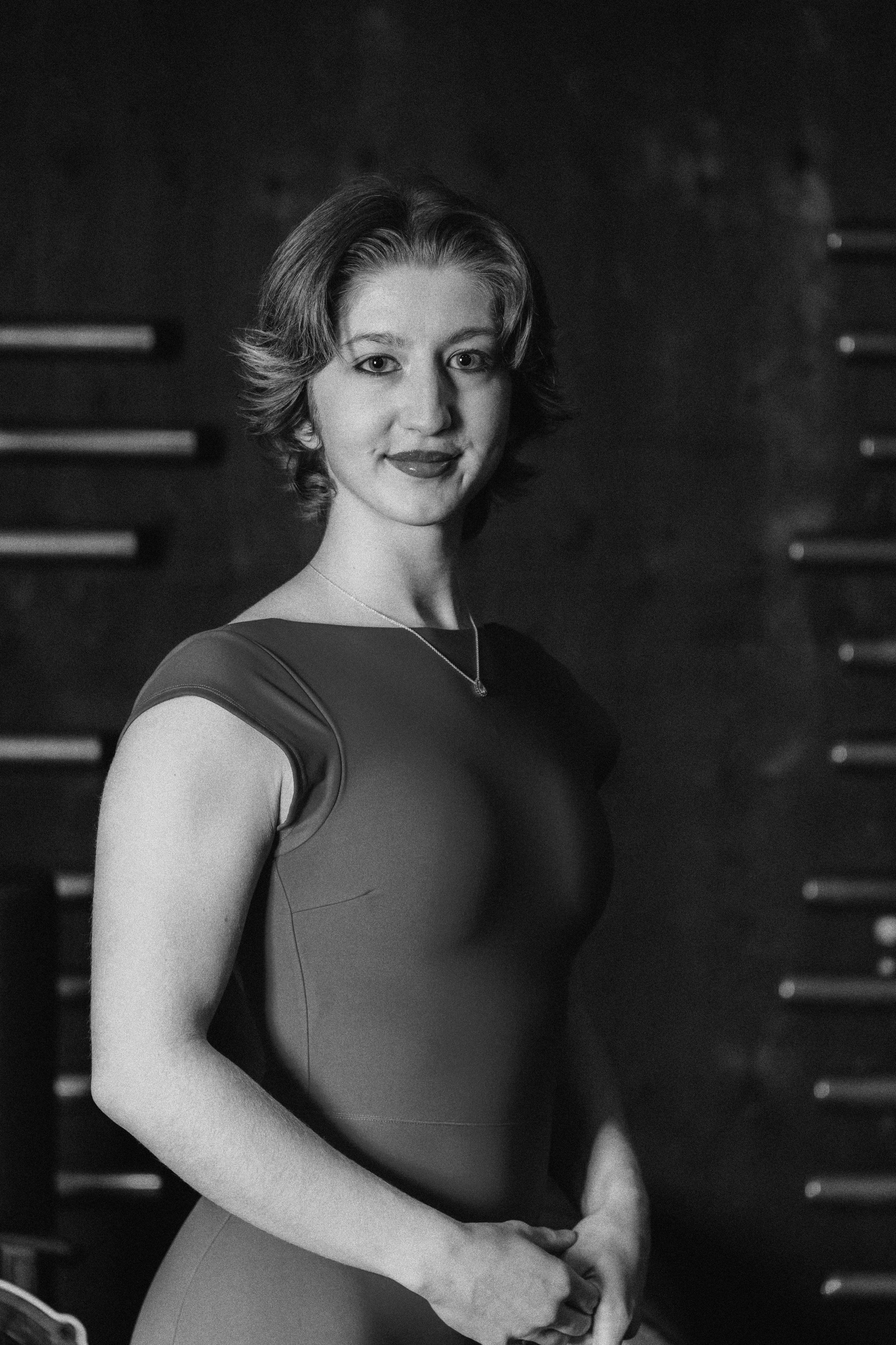 a woman in a wet suit standing on a beach
